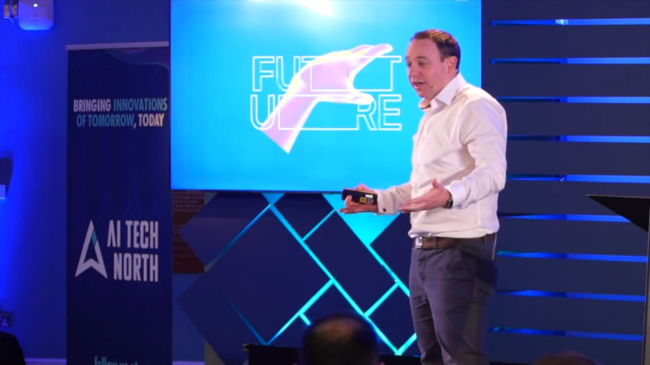 Jamie Hinton explaining AI transition frameworks on stage